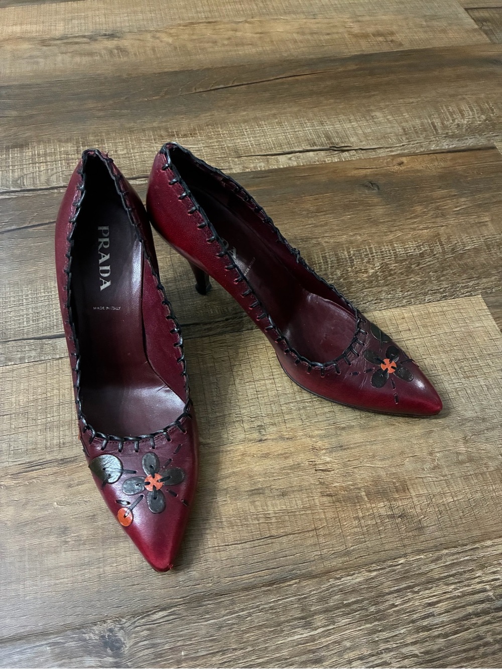 Prada Burgundy Leather Pointed-Toe Heels with Black & Orange Floral Appliqués
